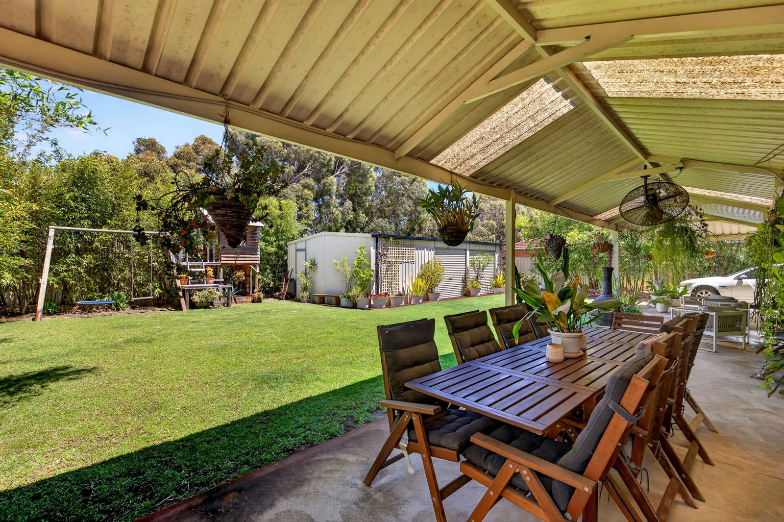 Gabled alfresco looking over the back lawn, swing set and shed