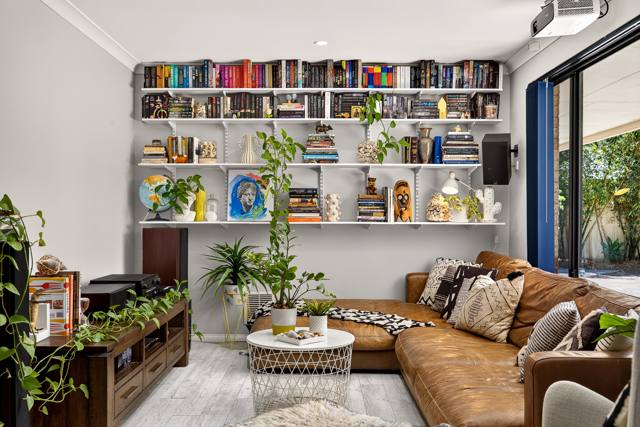 Front lounge with wall of shelving