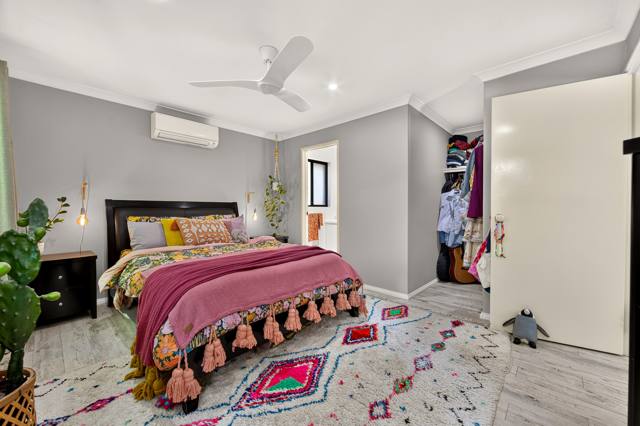 Main bedroom with ceiling fan and split system